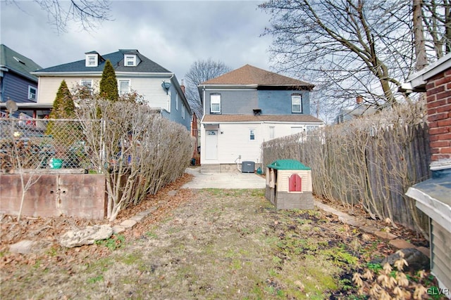 back of property with cooling unit and a patio area