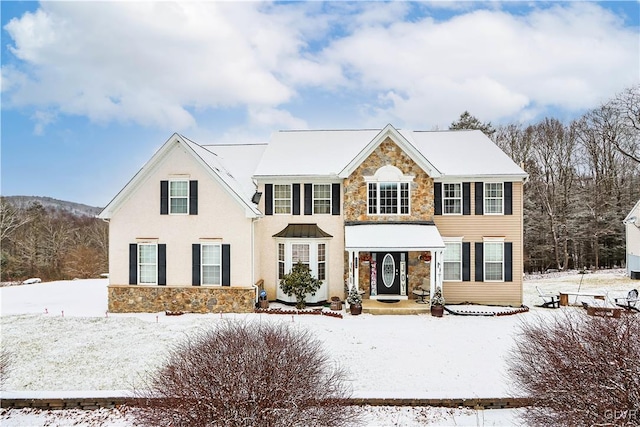 colonial house featuring stone siding