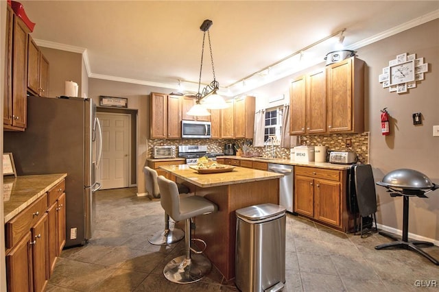 kitchen with stainless steel appliances, a kitchen island, decorative backsplash, and ornamental molding