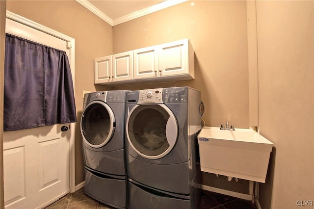 laundry area featuring cabinet space, tile patterned flooring, crown molding, washer and dryer, and a sink