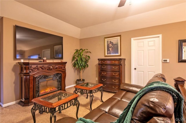 sitting room featuring carpet, a glass covered fireplace, ceiling fan, and baseboards