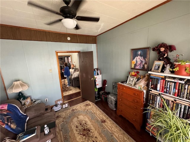 bedroom with hardwood / wood-style flooring, ceiling fan, and crown molding