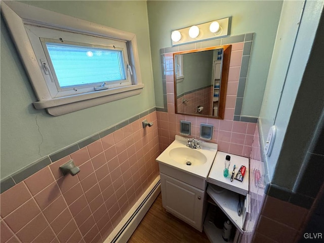 bathroom with vanity, tile walls, and a baseboard heating unit