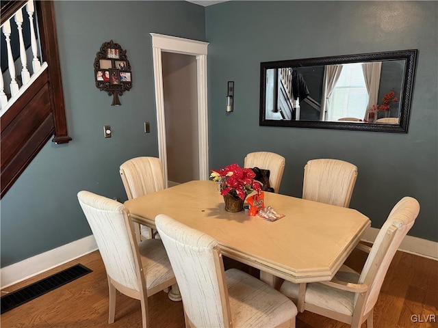 dining area with hardwood / wood-style floors