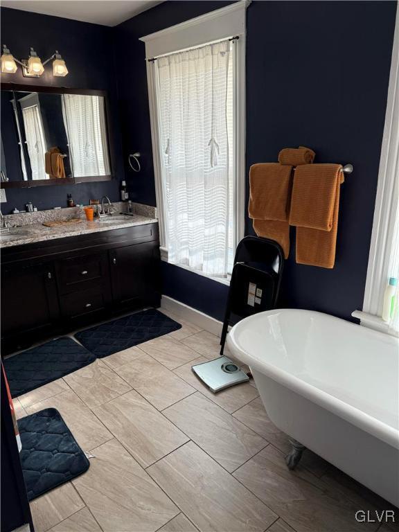 bathroom with vanity and a tub to relax in