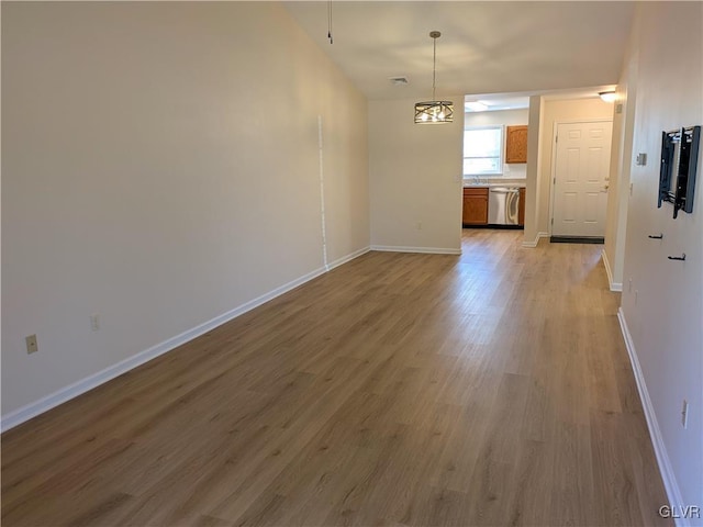 interior space featuring light wood-type flooring and an inviting chandelier