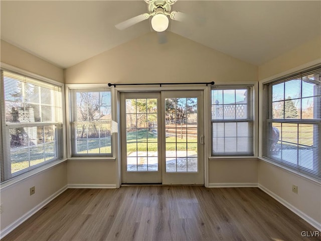 unfurnished sunroom featuring ceiling fan and vaulted ceiling