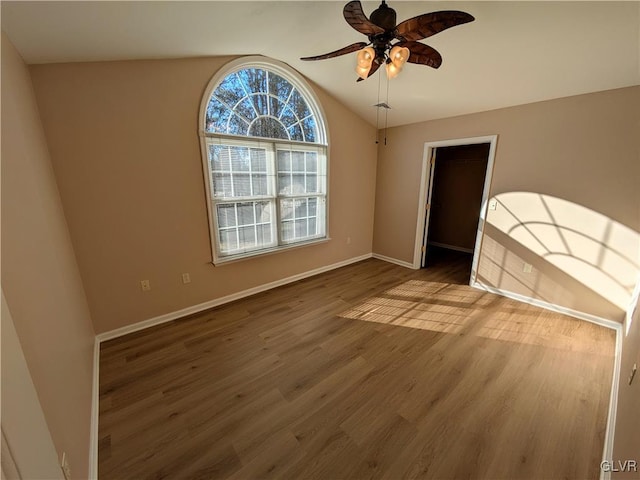 unfurnished room featuring vaulted ceiling, ceiling fan, and hardwood / wood-style flooring