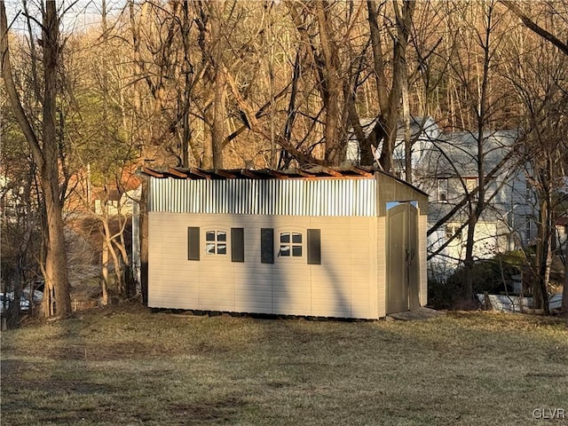 view of outbuilding with a yard