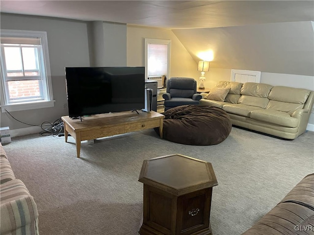 carpeted living room with vaulted ceiling