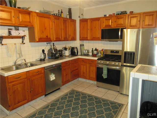 kitchen featuring backsplash, sink, light tile patterned floors, and stainless steel appliances