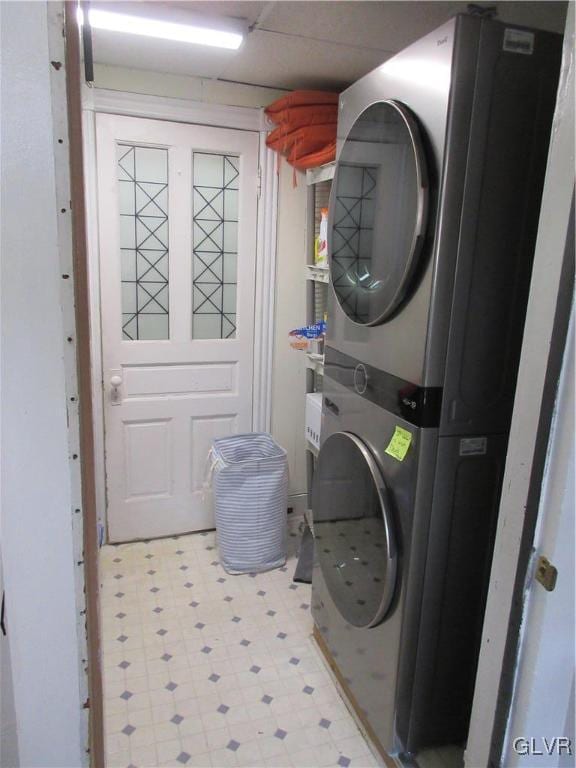 washroom featuring stacked washer and clothes dryer