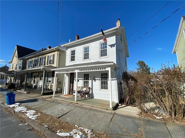 rear view of property with a porch