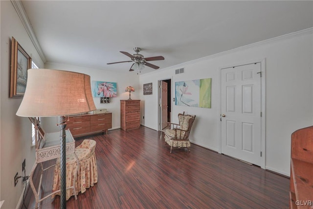 sitting room with dark hardwood / wood-style floors, ceiling fan, and crown molding