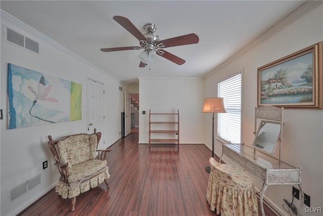 living area featuring dark wood-type flooring, ceiling fan, and ornamental molding