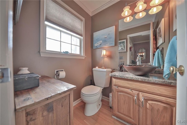 bathroom featuring vanity, toilet, wood-type flooring, and crown molding