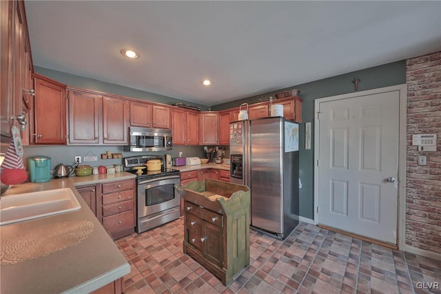 kitchen with brick wall, sink, and appliances with stainless steel finishes