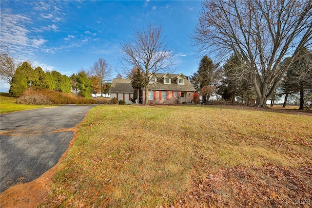 new england style home featuring a front lawn