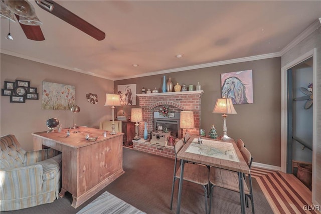 carpeted home office featuring ceiling fan, a fireplace, and ornamental molding