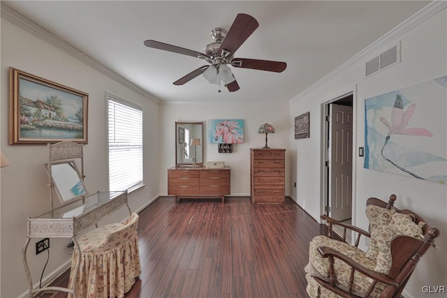 sitting room with dark hardwood / wood-style flooring, ceiling fan, and crown molding