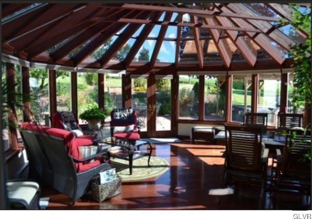 sunroom featuring a wealth of natural light and lofted ceiling