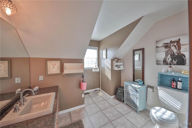 bathroom with tile patterned floors, sink, and vaulted ceiling