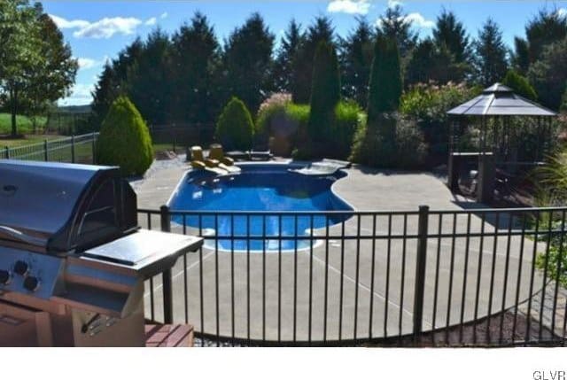 view of swimming pool with a gazebo and a patio