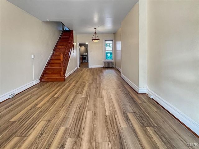 interior space featuring wood-type flooring and radiator heating unit