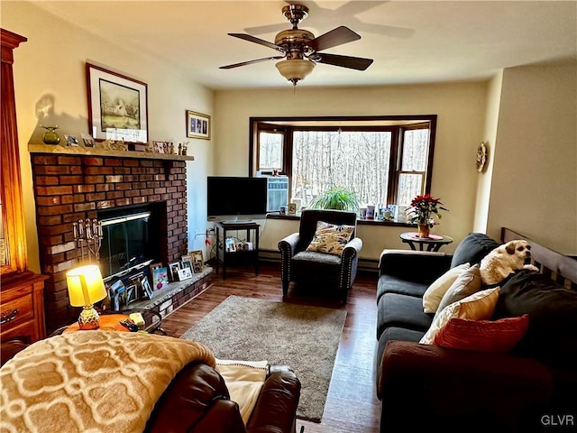 living room featuring ceiling fan, a fireplace, and dark hardwood / wood-style floors