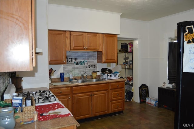 kitchen featuring tasteful backsplash, sink, and ornamental molding