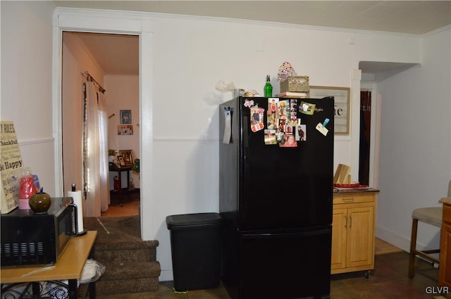 kitchen featuring light brown cabinets, black appliances, and ornamental molding