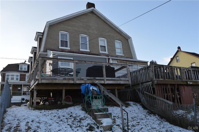 snow covered property with a deck