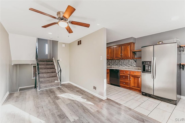 kitchen with stainless steel refrigerator with ice dispenser, ceiling fan, black dishwasher, tasteful backsplash, and light tile patterned flooring