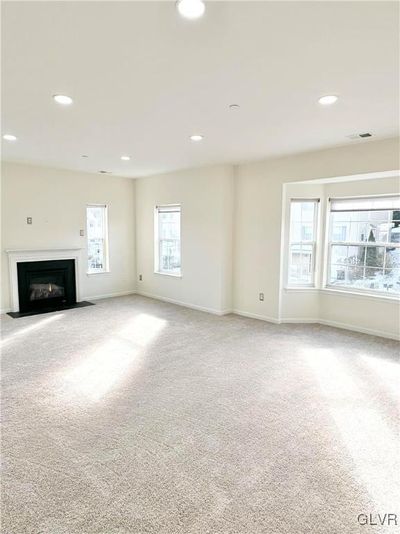 unfurnished living room featuring carpet