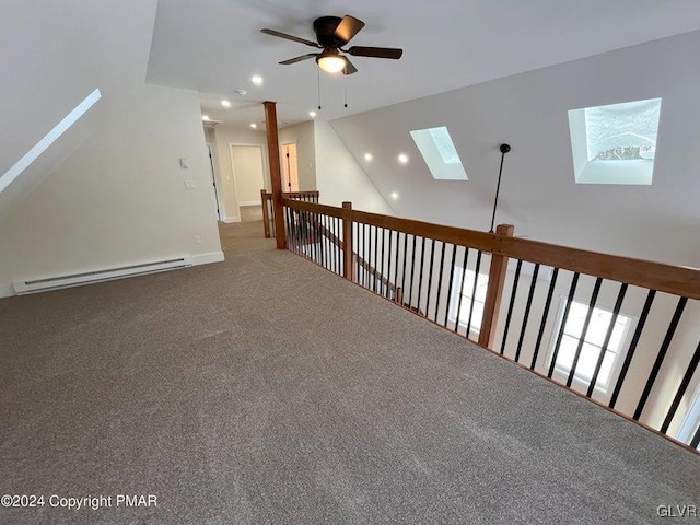 bonus room with carpet flooring, ceiling fan, a baseboard radiator, and lofted ceiling with skylight