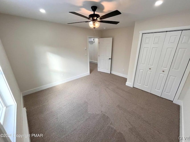 unfurnished bedroom with ceiling fan, carpet floors, and a closet