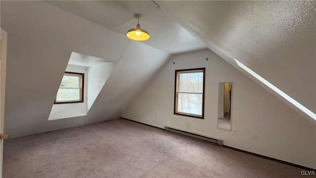 9860 Deerwood Dr, Coolbaugh Twp, PA 18466 - additional living space featuring a baseboard radiator, lofted ceiling, plenty of natural light, and carpet