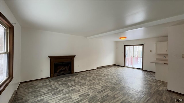 9860 Deerwood Dr, Coolbaugh Twp, PA 18466 - unfurnished living room with wood finished floors, a baseboard radiator, and a fireplace with flush hearth