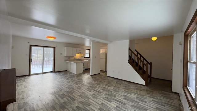 9860 Deerwood Dr, Coolbaugh Twp, PA 18466 - unfurnished living room featuring light wood-type flooring and stairs