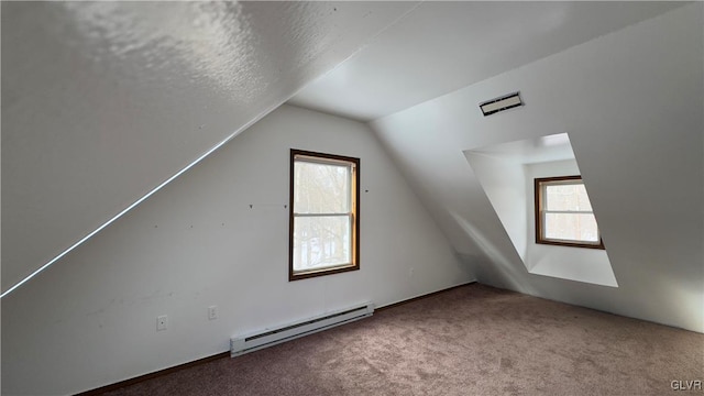 9860 Deerwood Dr, Coolbaugh Twp, PA 18466 - additional living space featuring a baseboard heating unit, carpet floors, plenty of natural light, and lofted ceiling