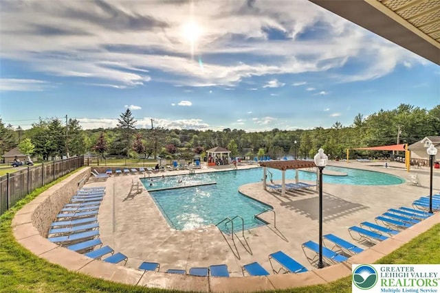 9860 Deerwood Dr, Coolbaugh Twp, PA 18466 - community pool featuring a patio area and view of scattered trees