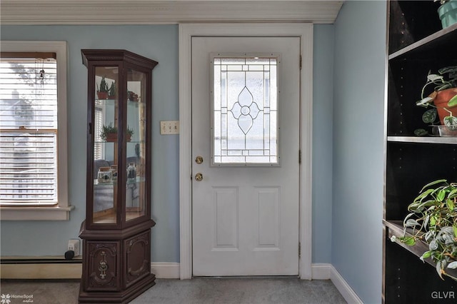 doorway to outside with carpet and baseboard heating