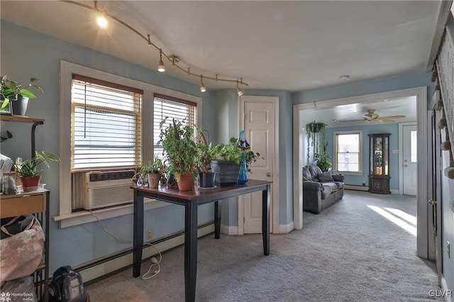 office area featuring light carpet, a baseboard heating unit, ceiling fan, and cooling unit