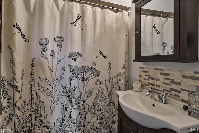 bathroom with vanity, tasteful backsplash, and curtained shower