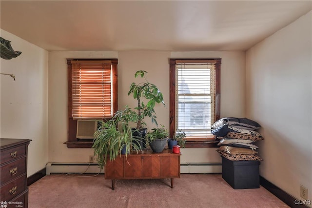 living area with cooling unit, a baseboard radiator, and light colored carpet