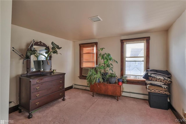 living area featuring light colored carpet and a baseboard heating unit