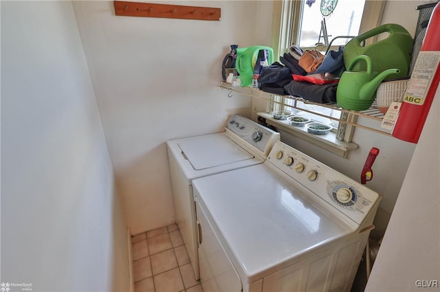 clothes washing area featuring separate washer and dryer and light tile patterned flooring