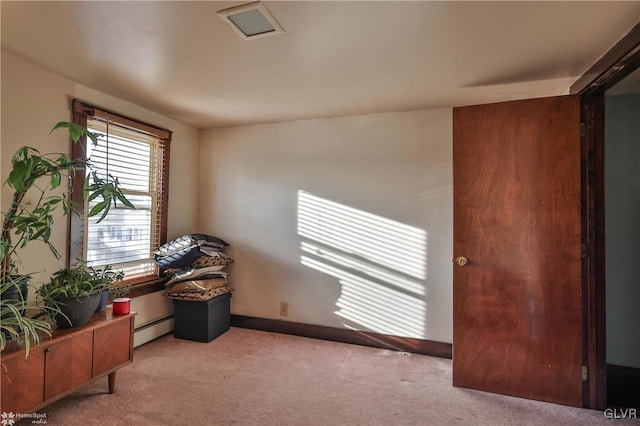 sitting room featuring light carpet and a baseboard radiator