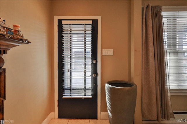 doorway to outside with light tile patterned floors