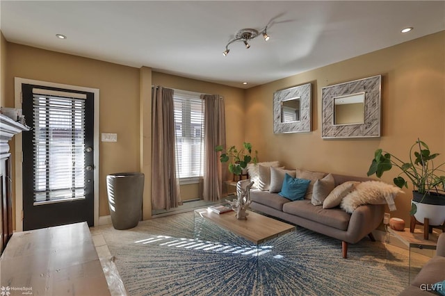 living room with a fireplace, light tile patterned floors, and a wealth of natural light